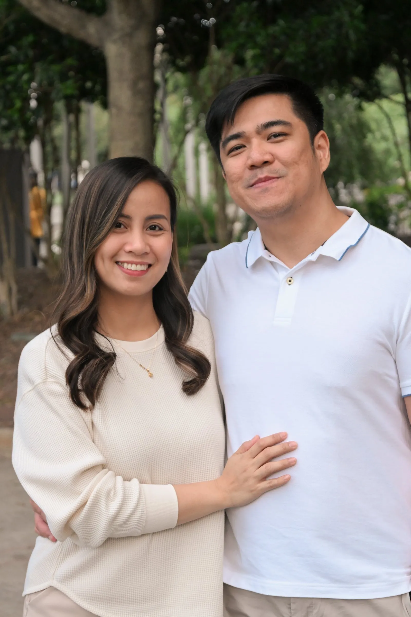 Jessica and Jet standing close under the trees, her hand on his chest