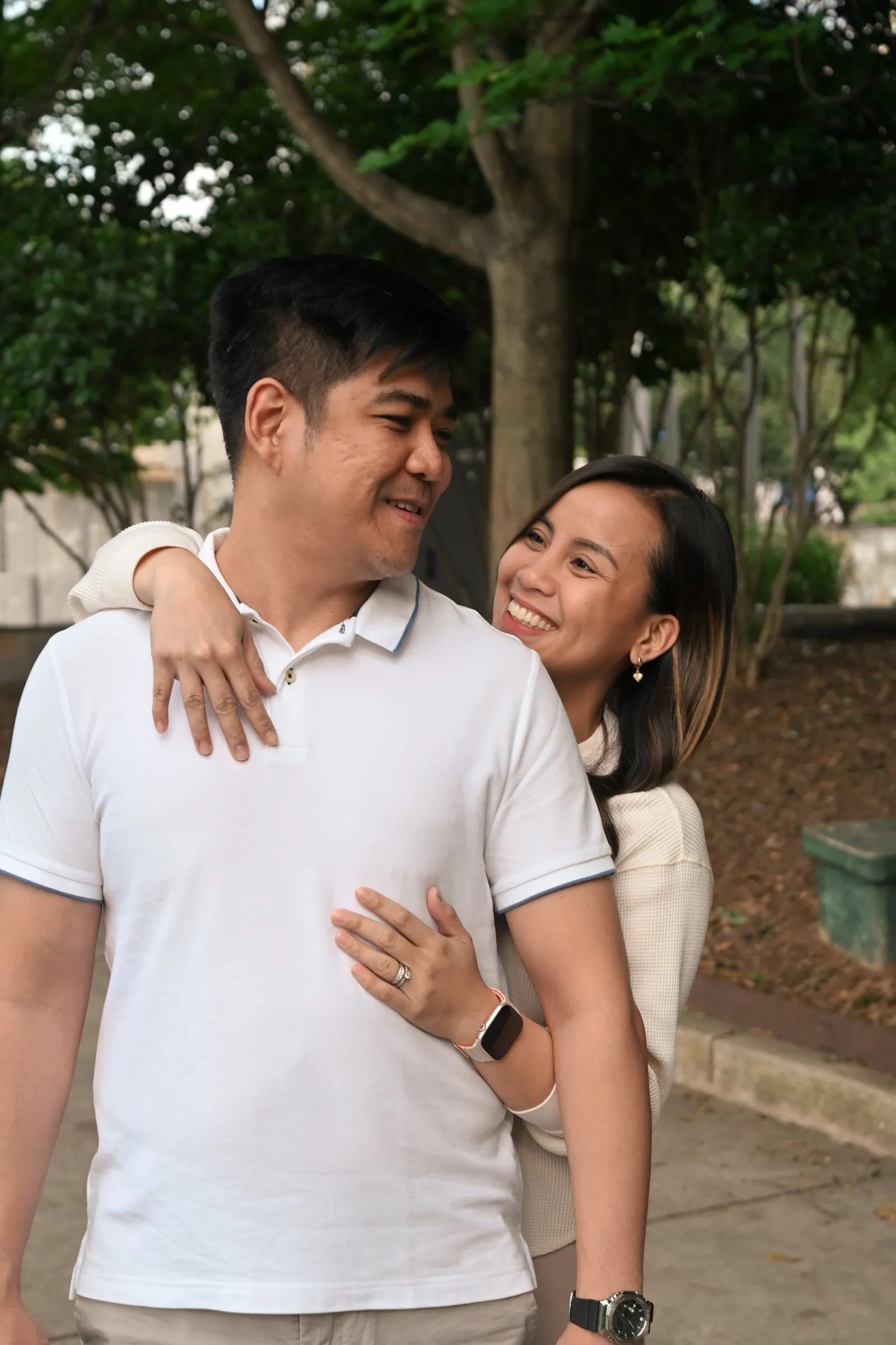 Jessica wraps her arms around Jet from behind and smiles at him