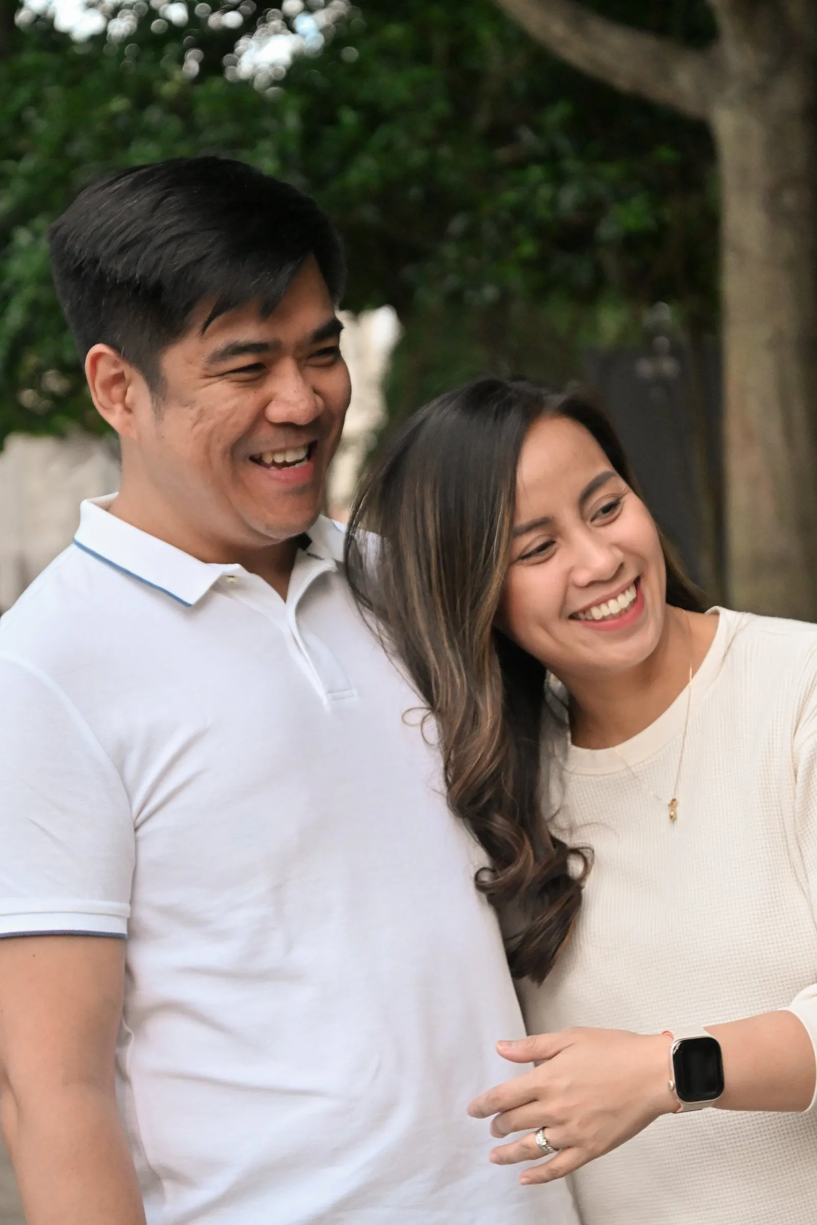 Jet and Jessica laughing together, her head against his shoulder