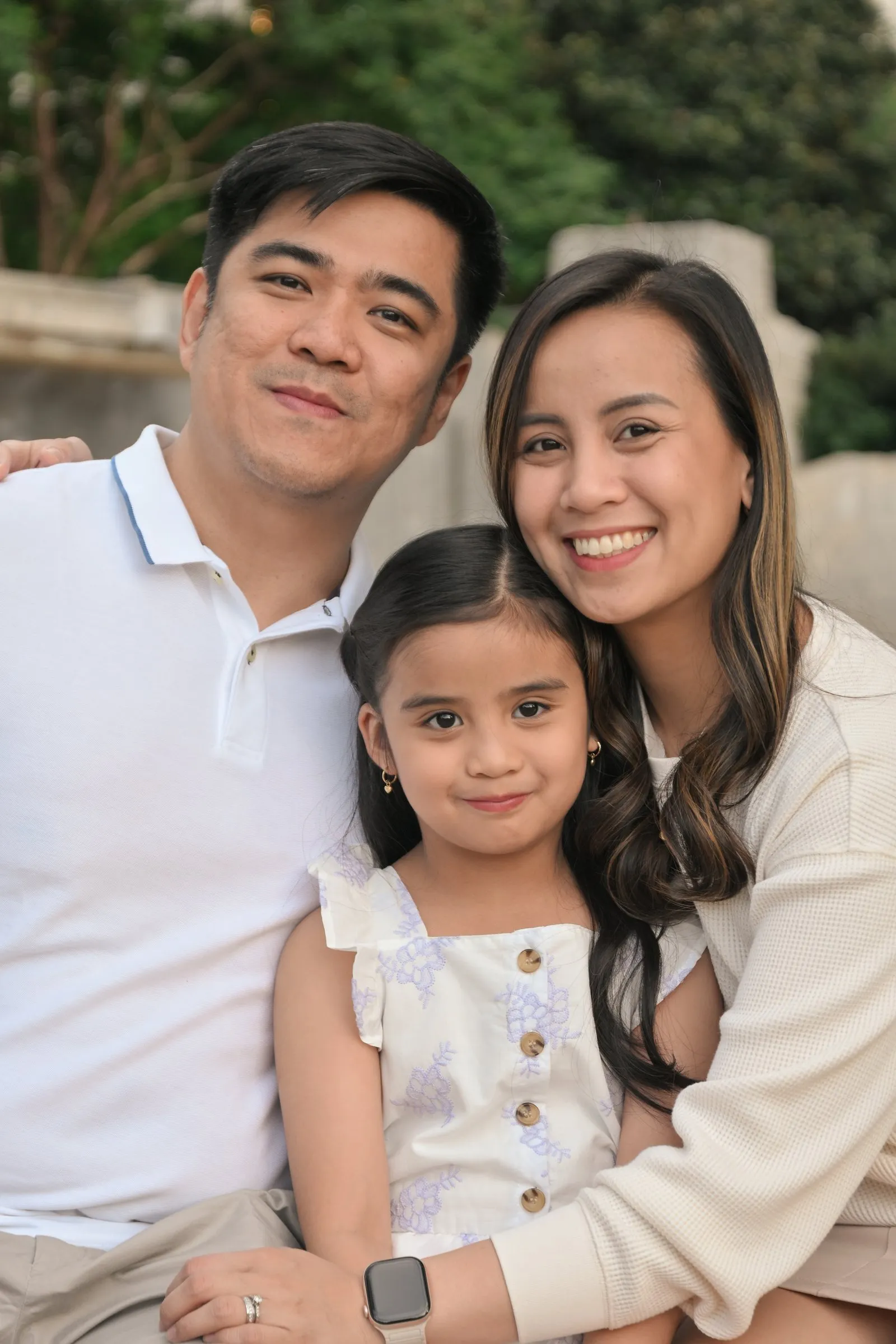 Close family portrait with their daughter tucked between Jet and Jessica