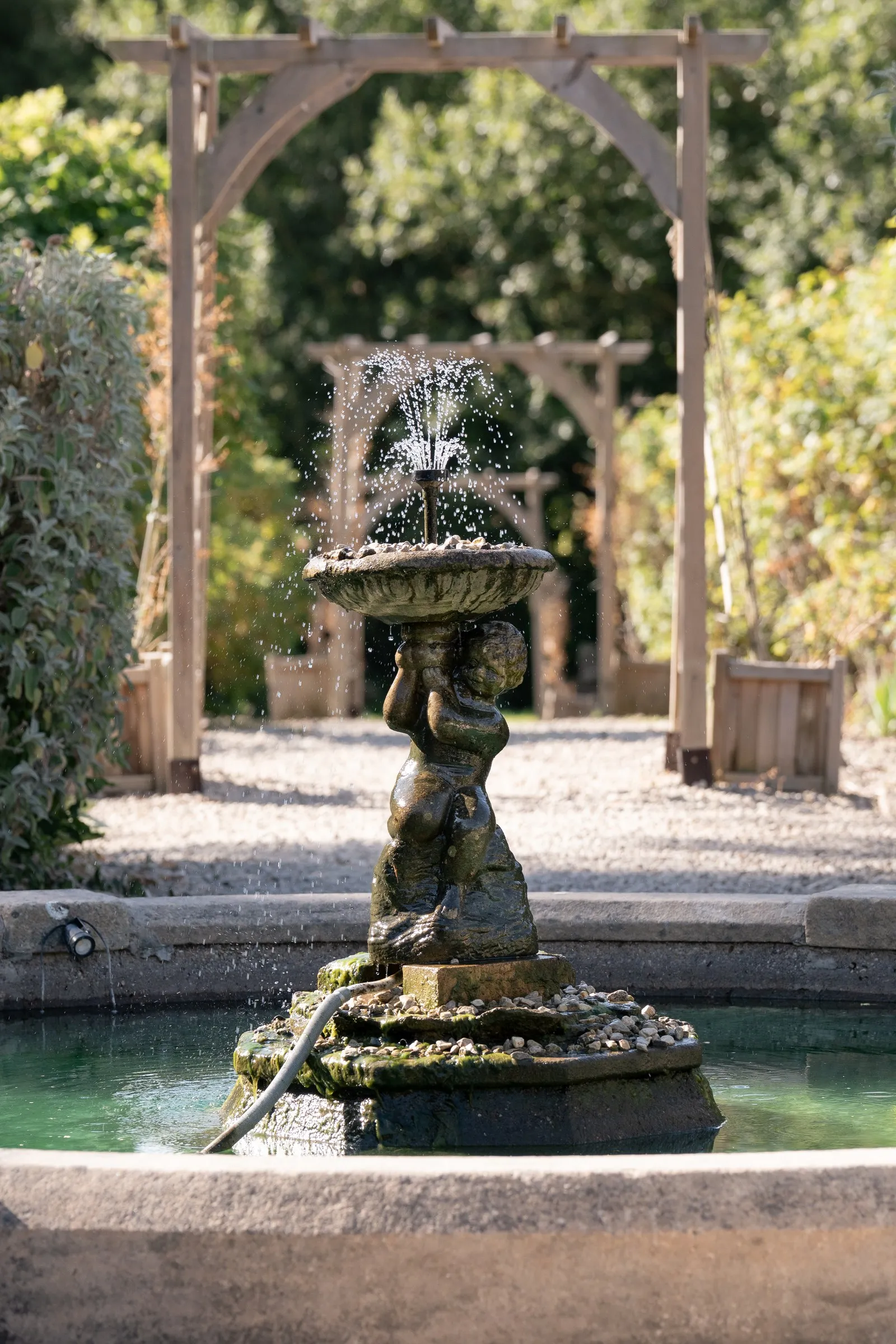 Stone fountain in the garden courtyard at Rothley Court