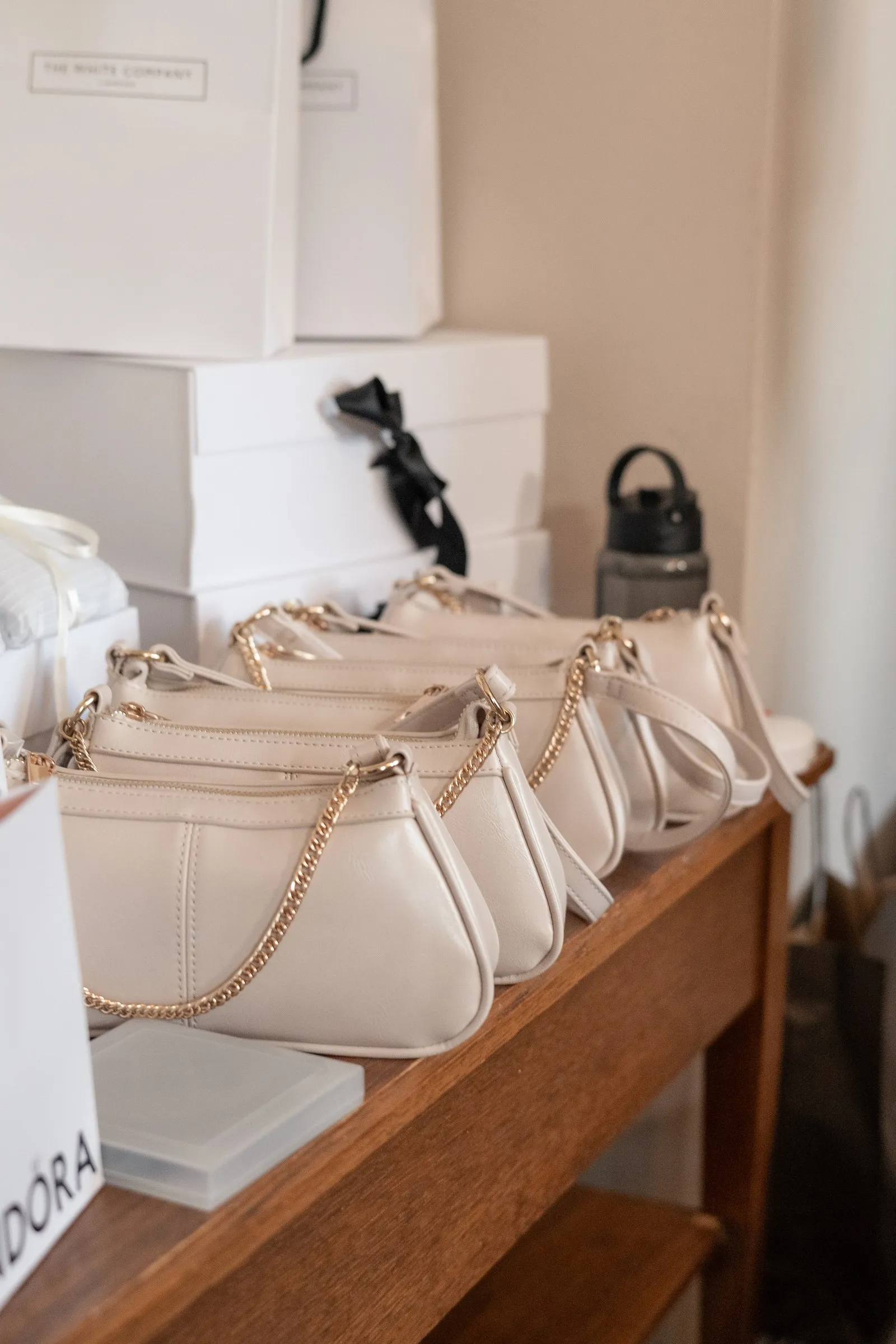 White gift bags lined up for the bridesmaids