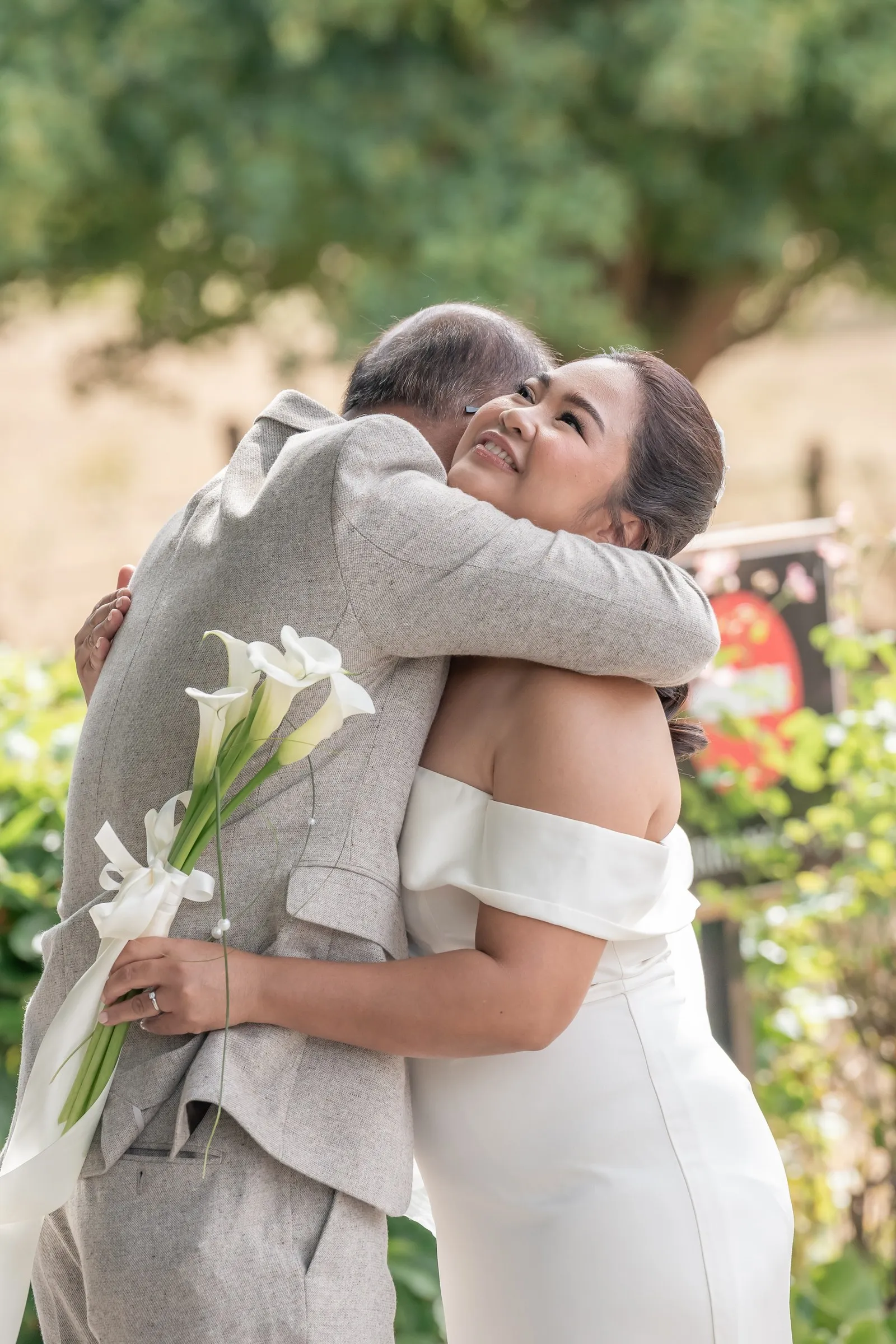 Mathelle hugging her dad, overcome with emotion during their first look