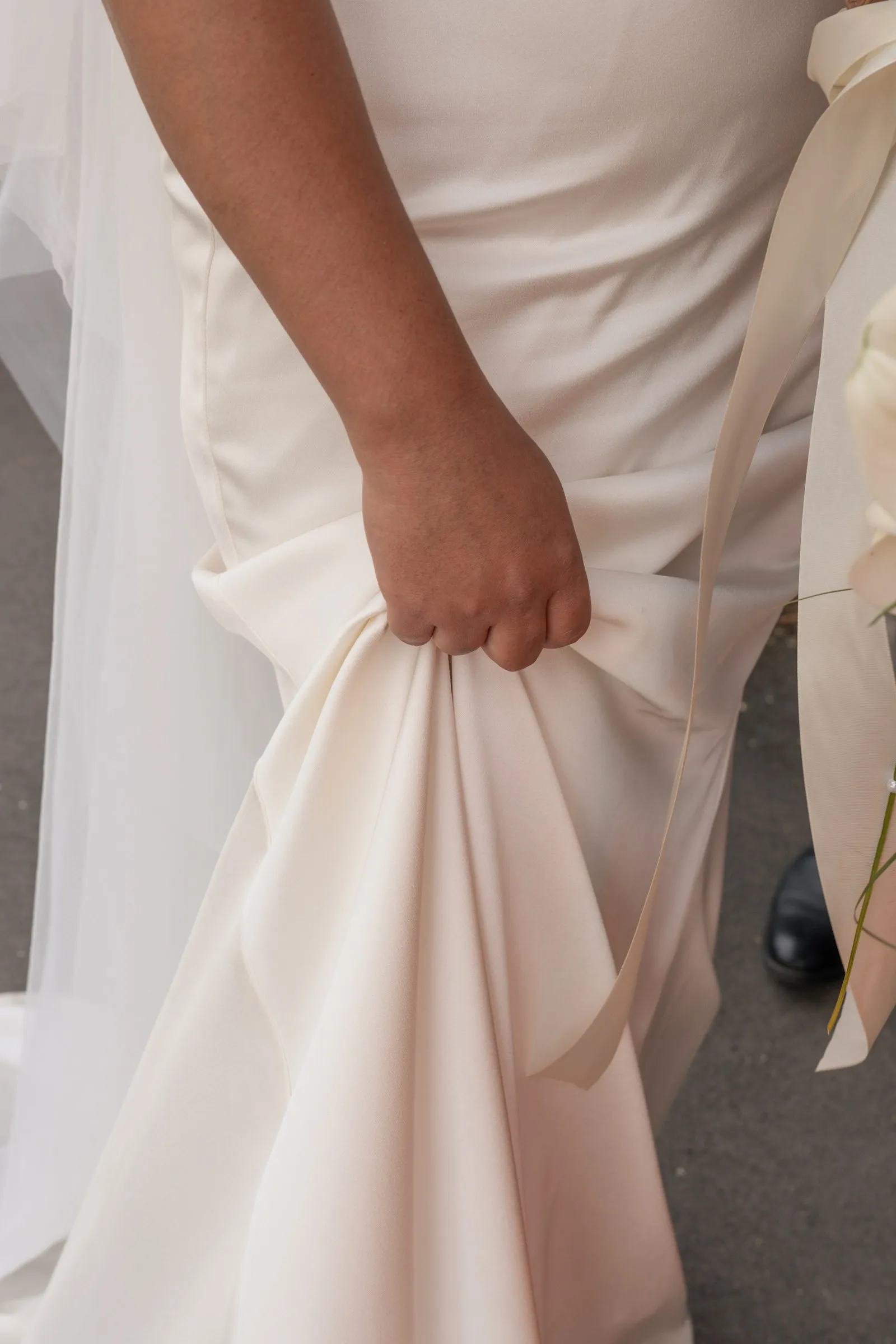 Mathelle lifting the skirt of her gown