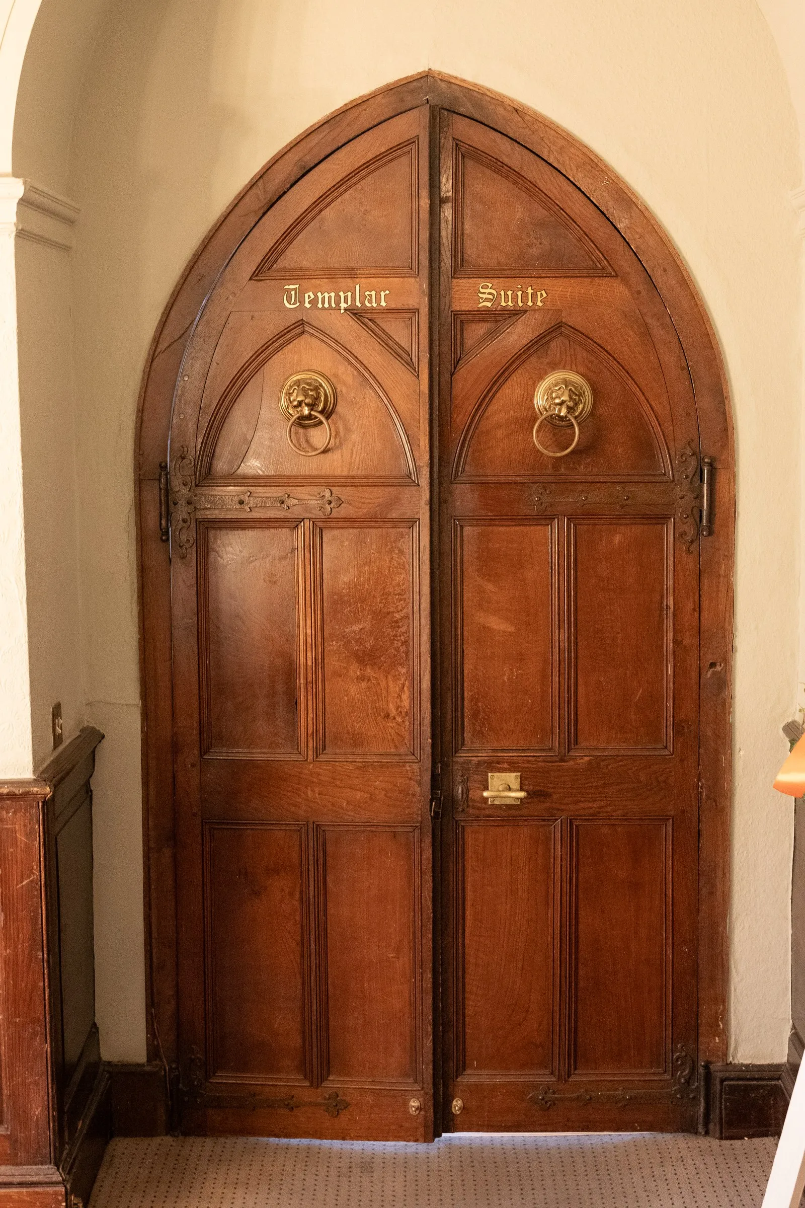 Arched oak door to the Templar Suite at Rothley Court