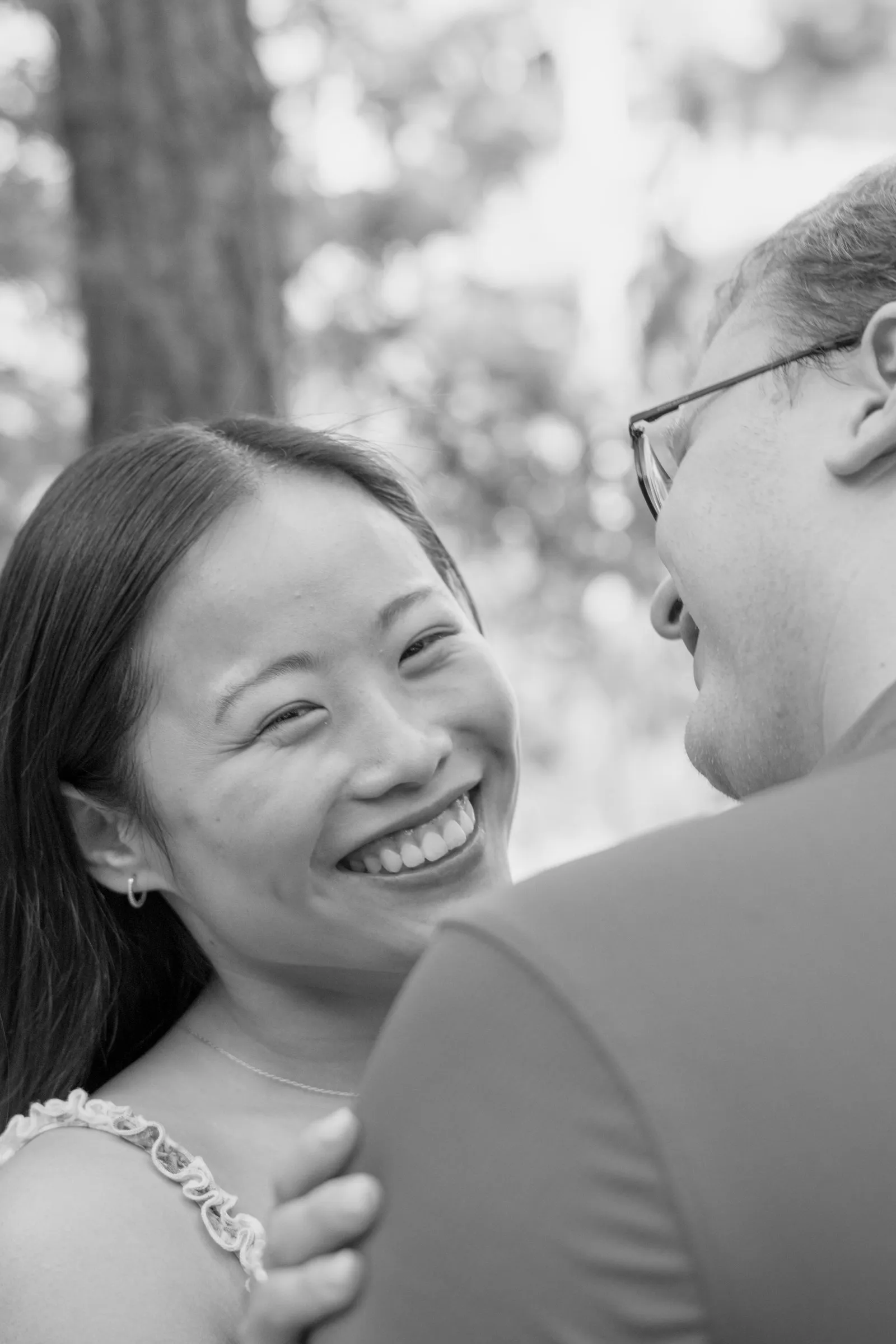 Black and white portrait of Mya laughing as she looks up at Jacob