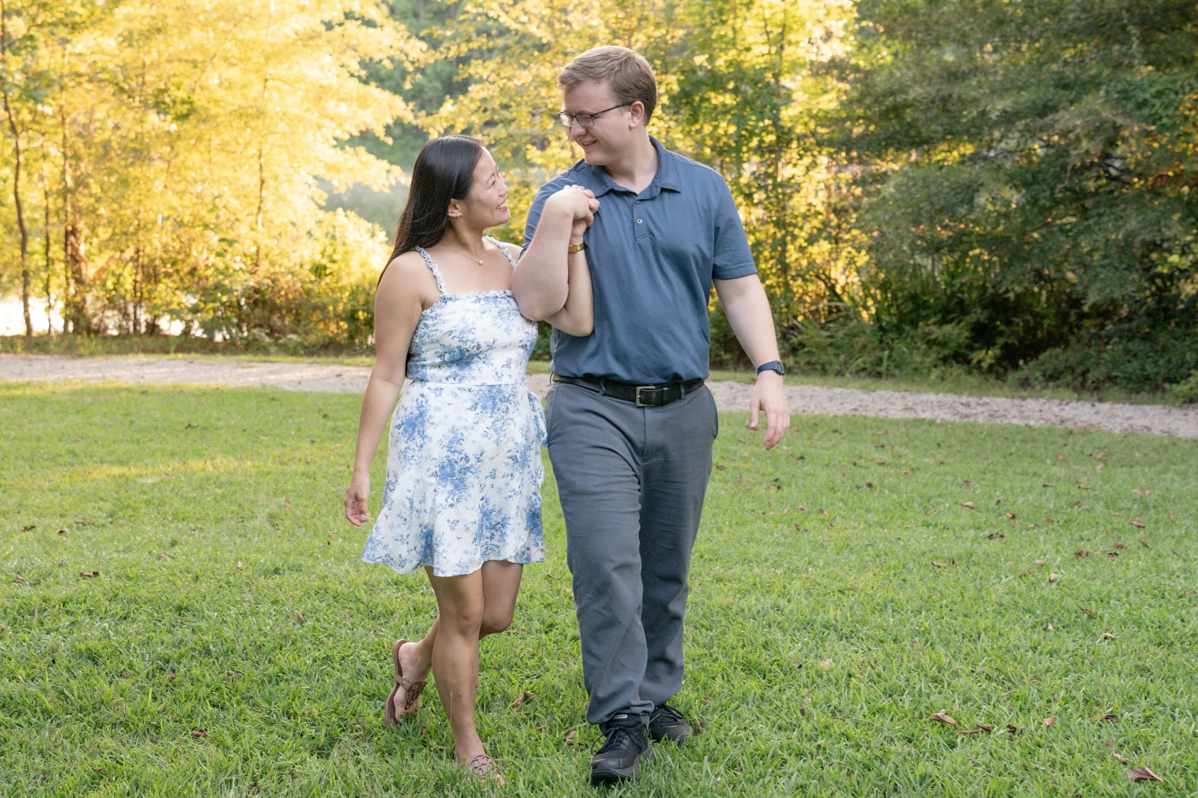 Mya and Jacob walking toward the camera, laughing and holding hands