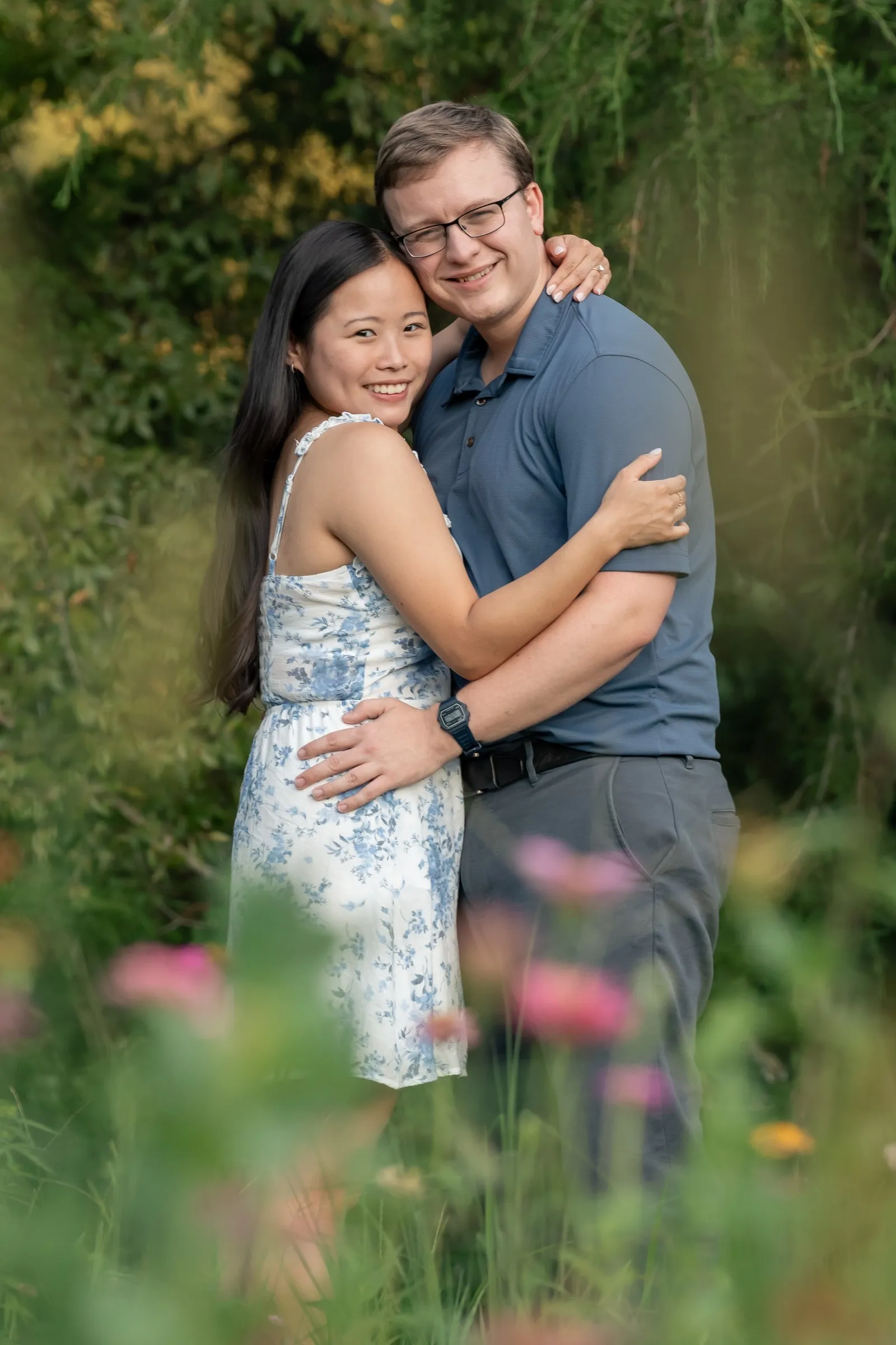 Mya and Jacob smiling at the camera in a field of wildflowers