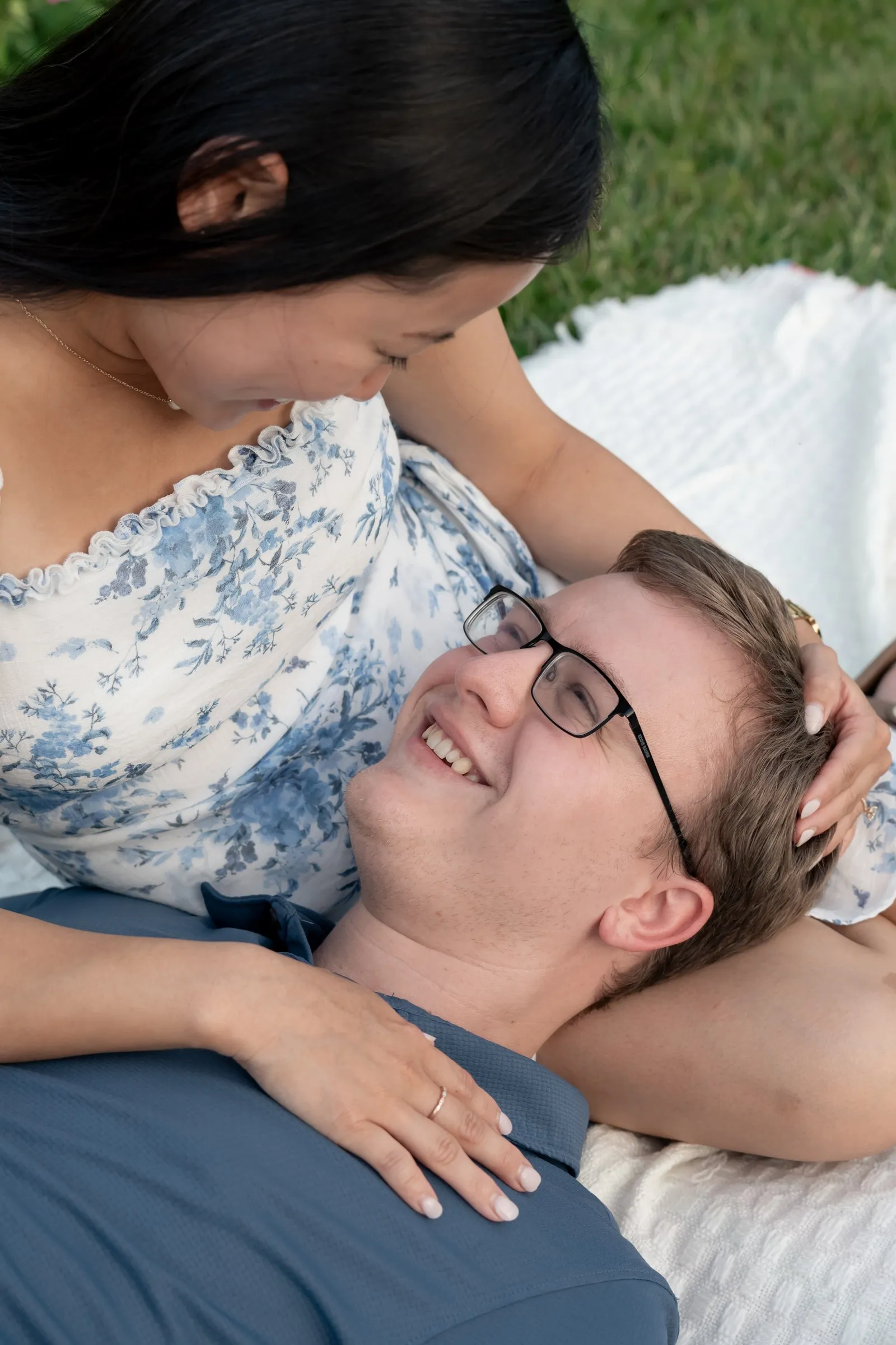 Jacob resting his head in Mya's lap and smiling up at her