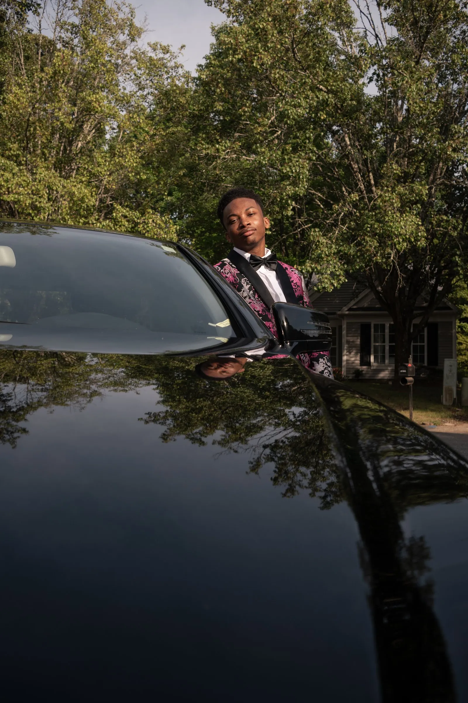 Seen across the long roofline of the black Mercedes