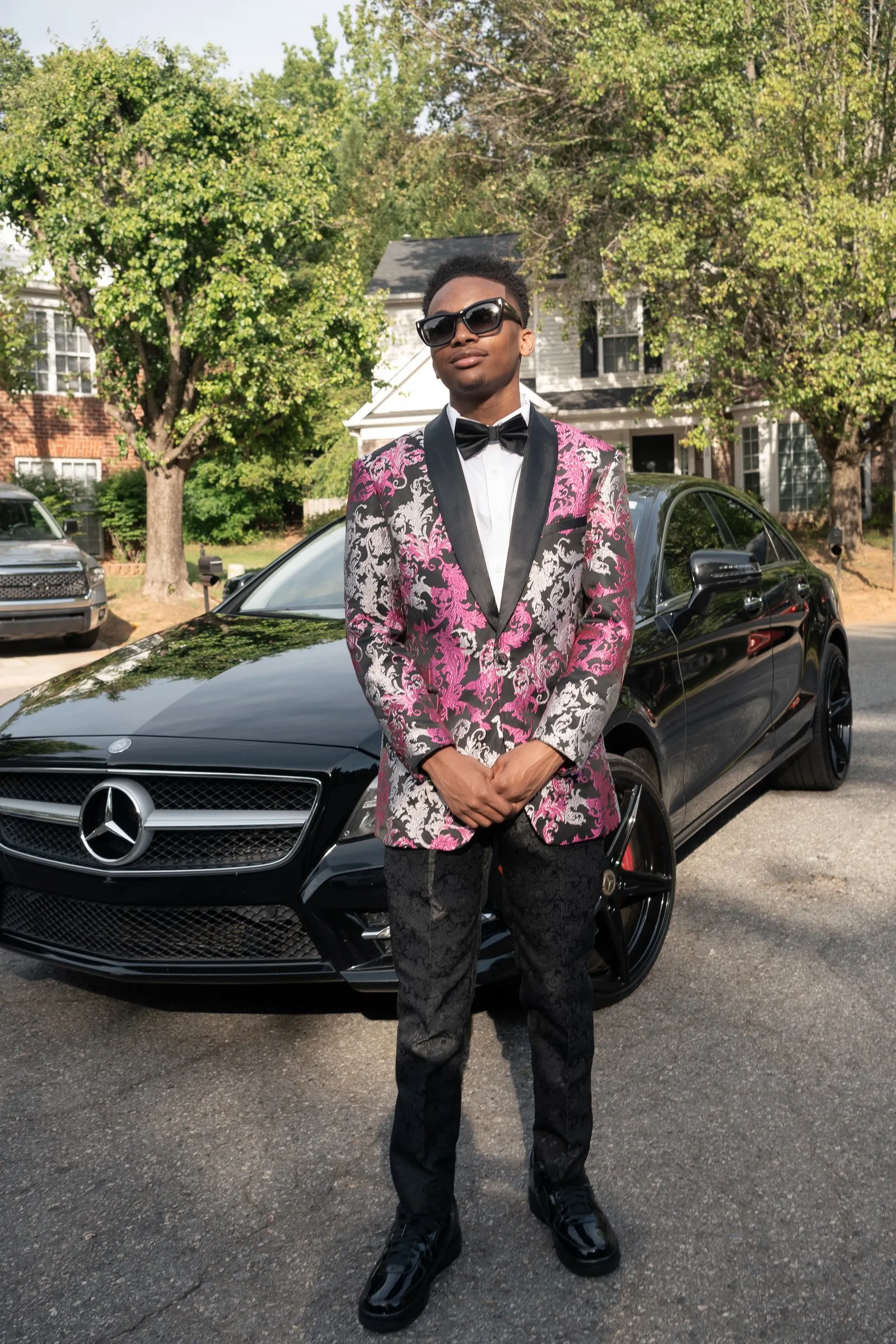 Full length portrait in front of the Mercedes grille
