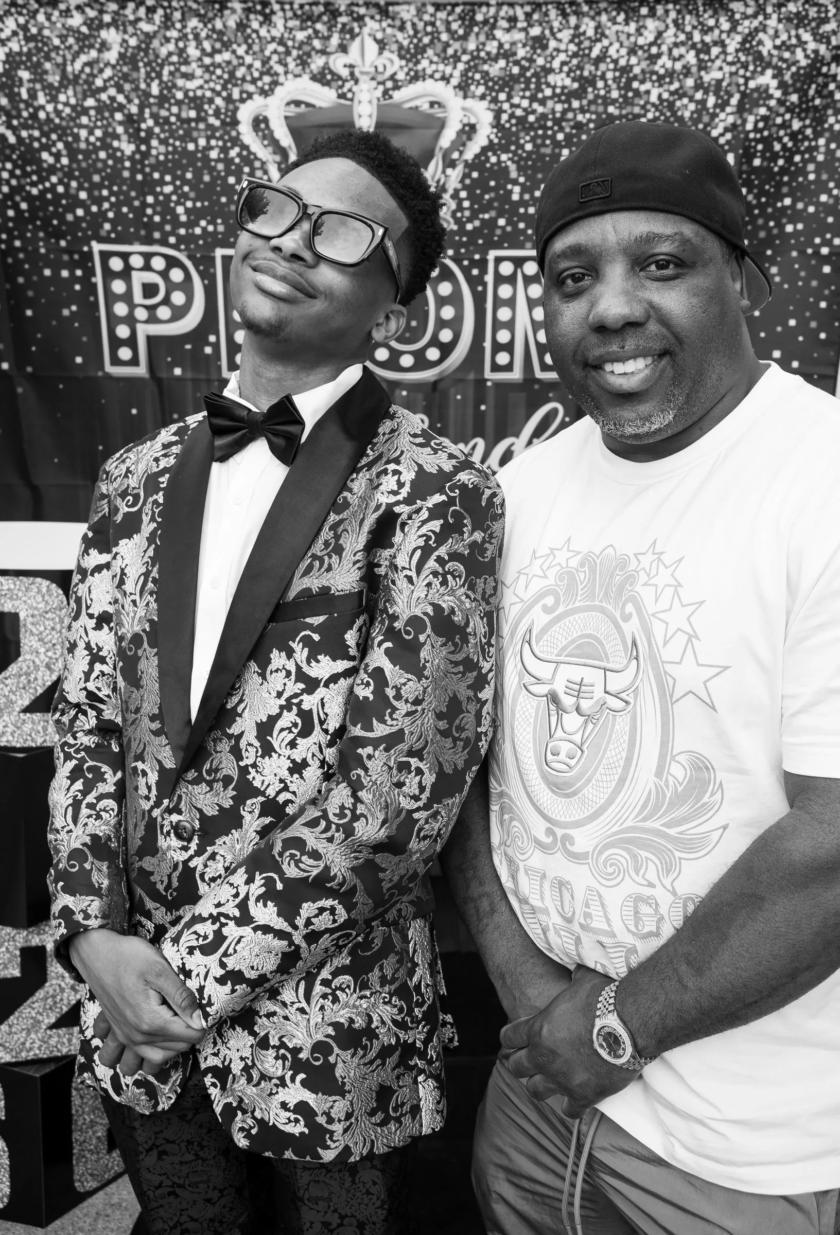 Black and white photograph of him with a guest in a black beanie
