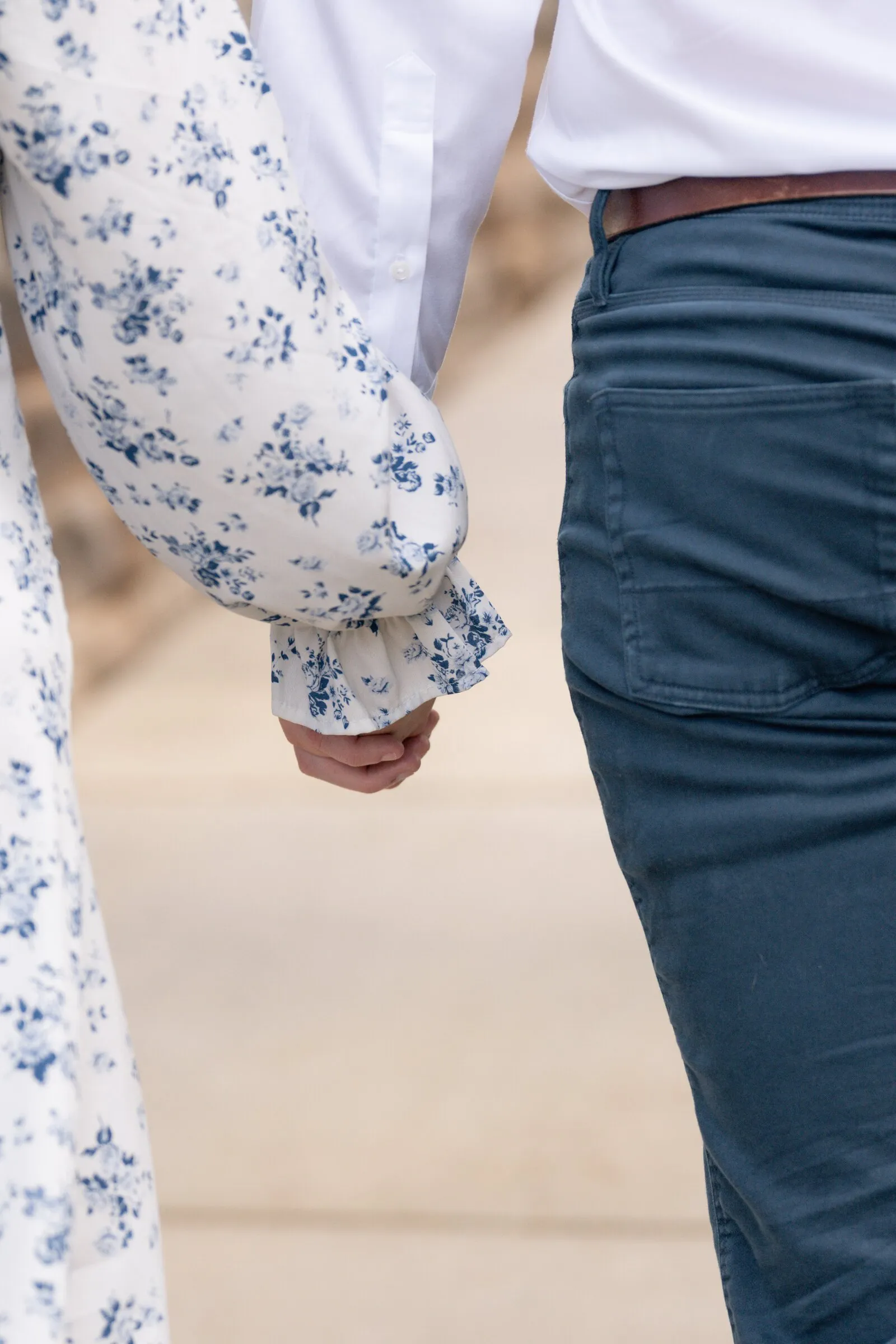 Detail of Spencer and Kayla's joined hands as they walk
