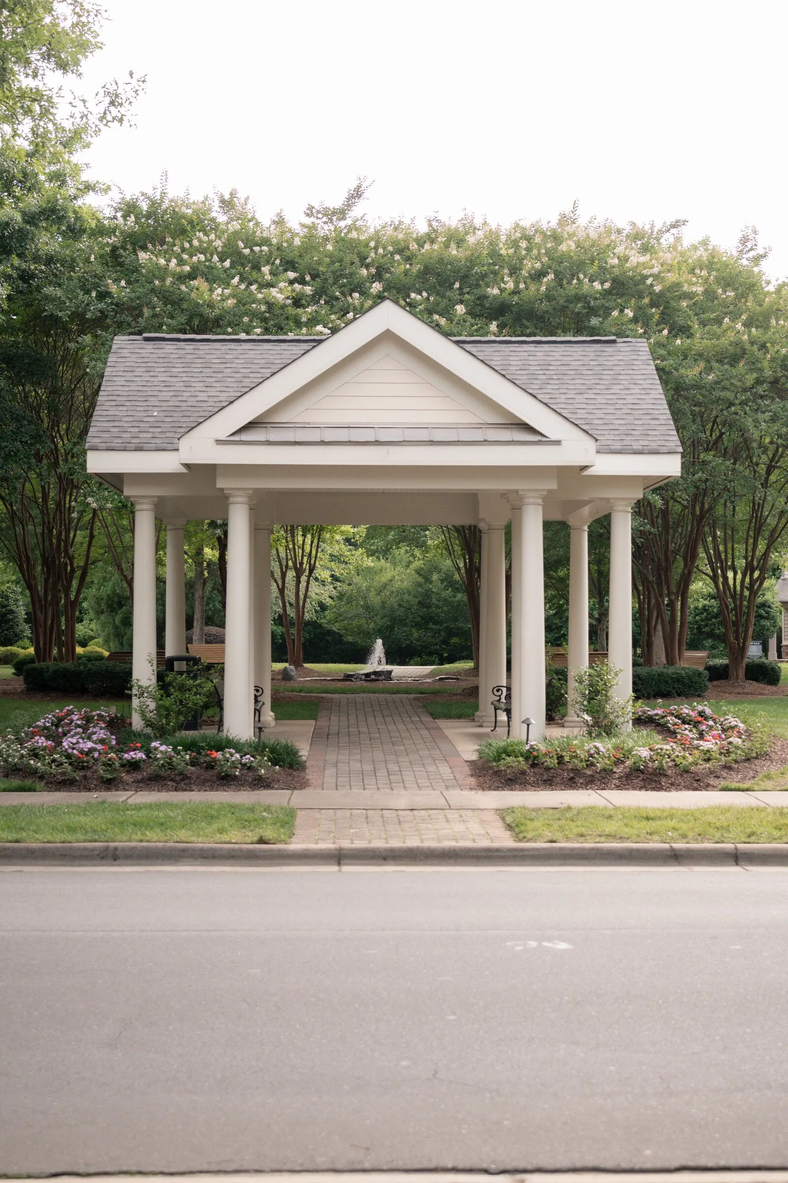 The white columned pavilion at Millbridge, with its fountain and flower beds